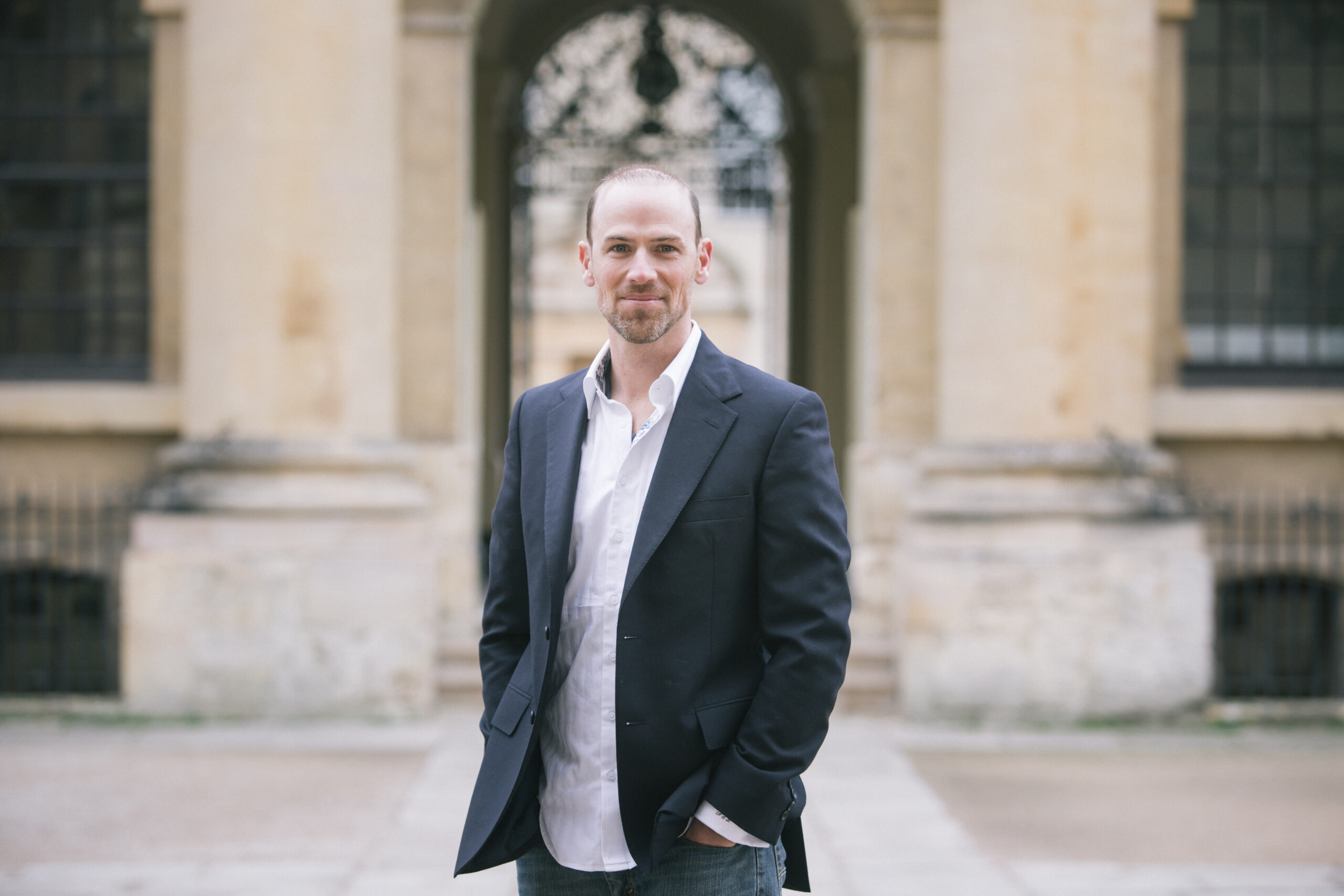 Andrew Luers, Co-founder and CEO of Habitat Energy stands outside the Bodleian Library, Oxford.