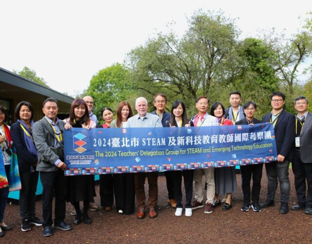 A group of people holding a banner