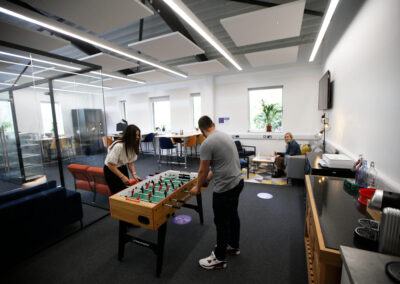 People play at a table football within the lounge area of the Barclays Eagle labs co-working space at the Wood Centre for Innovation.