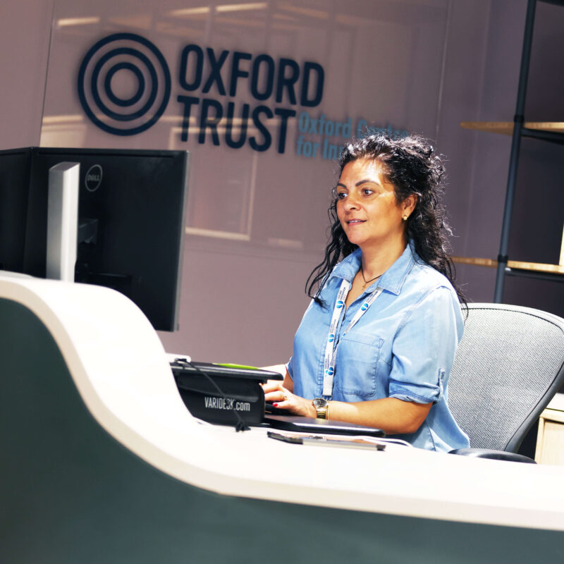 Cleo, reception, Oxford Centre for Innovation, Blue Board Court Assistant Centre Manager, Cleo sits at the reception of Blue Board Court, the new home of the Oxford Centre for Innovation- 2025.