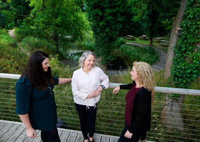 A team stand on the outdoor deck outside the cafe at the Wood Centre for Innovation.