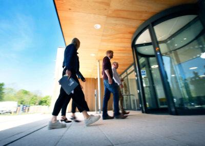 People walking into the entrance of the Wood Centre for Innovation