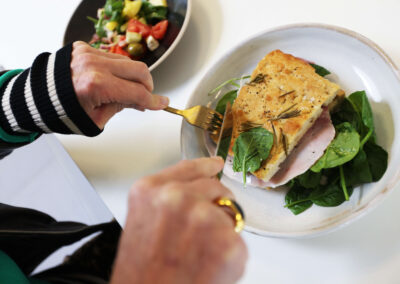 Someone eats lunch of a sandwich and salad at the cafe, Wood Centre for Innovation