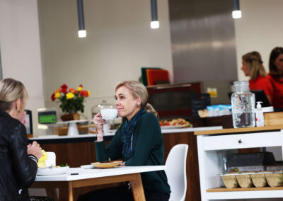 People sit using the cafe area for a meeting at the Wood Centre for Innovation
