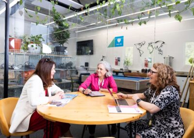 Team sitting at a meeting desk in the Barclays Eagle Lab at the Wood Centre for Innovation, May 2025.