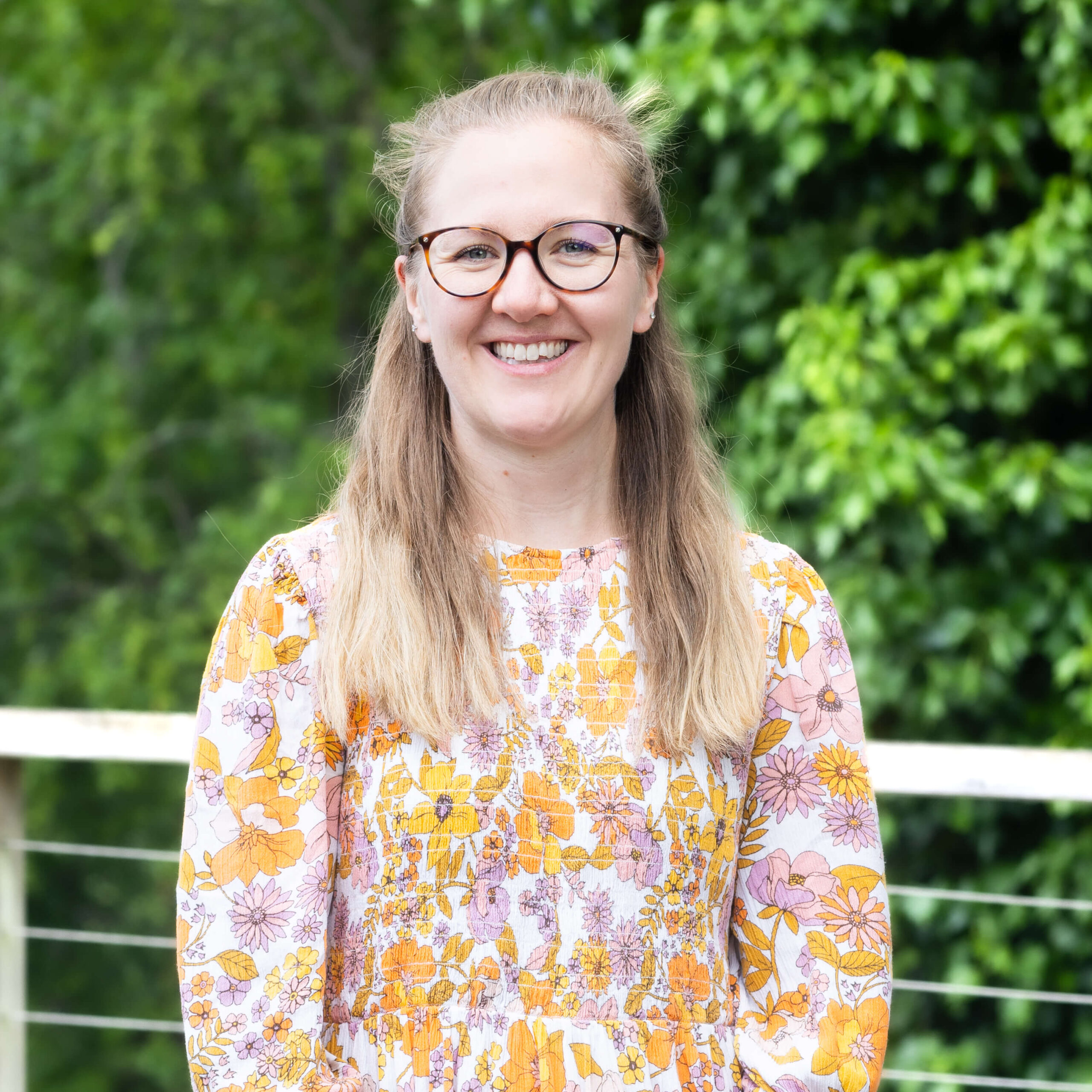 A member of The Oxford Trust team stands outside the Wood Centre for Innovation.