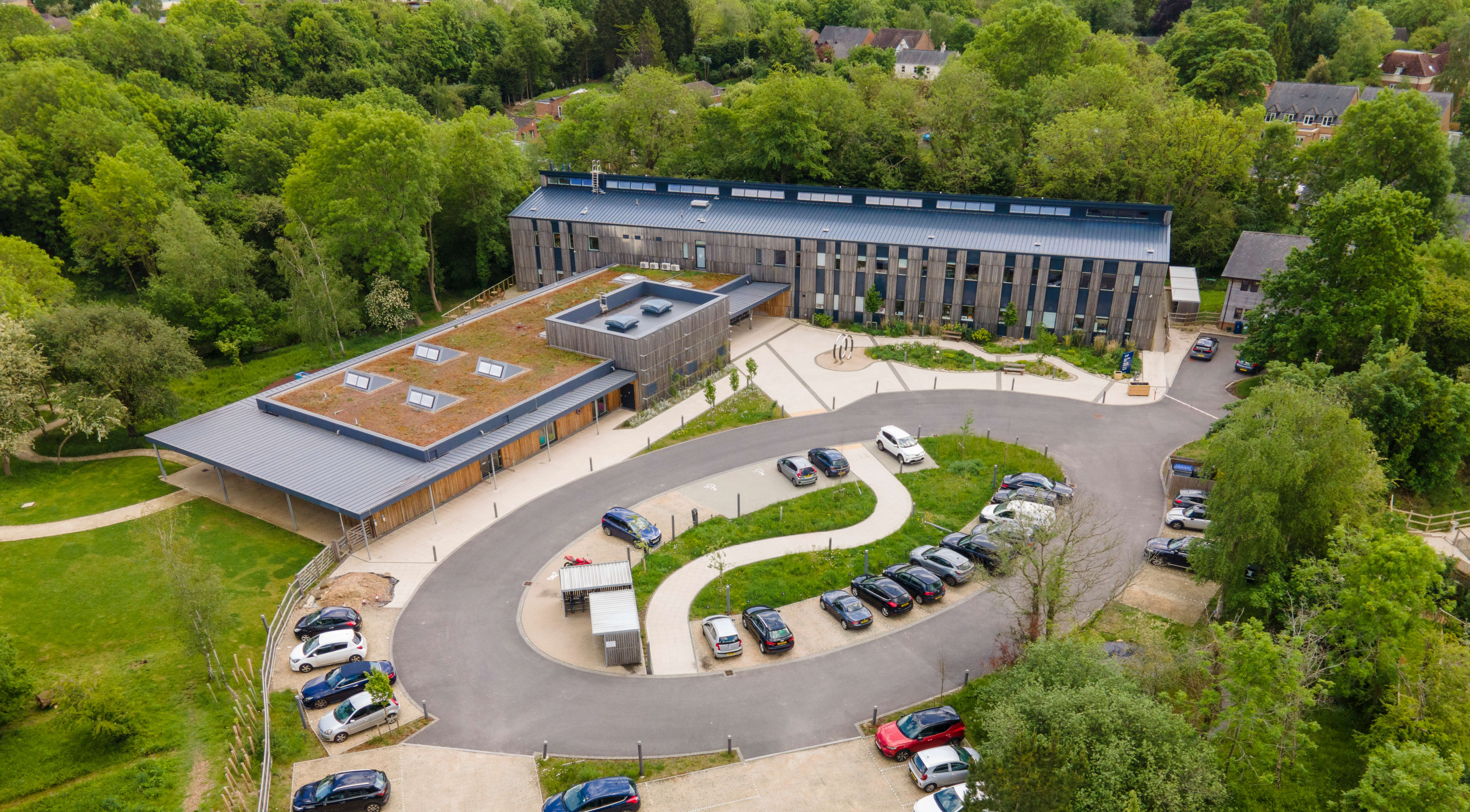 An ariel shot of the Wood Centre for Innovation showing the buildings, car park and surrounding wooded area.